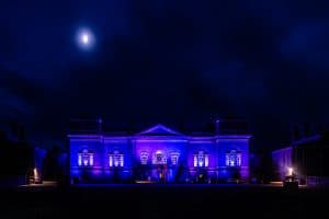 Holkham Hall lit up with blue lights.